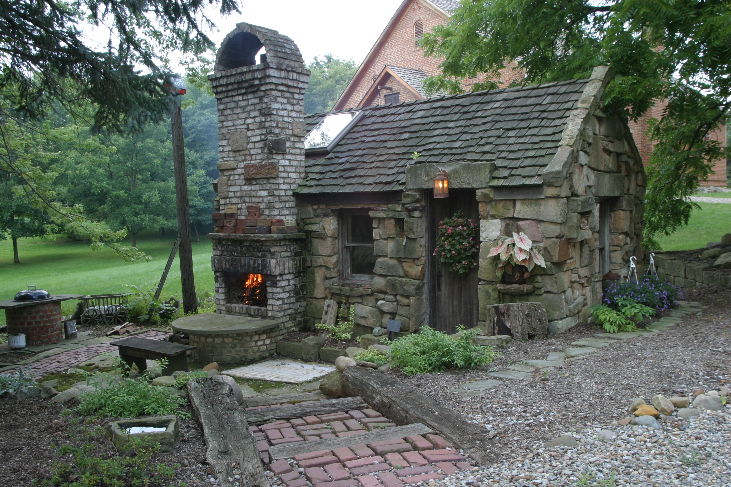 Indoor-outdoor fireplace, patio, and garden shed. Re-purposed barn 